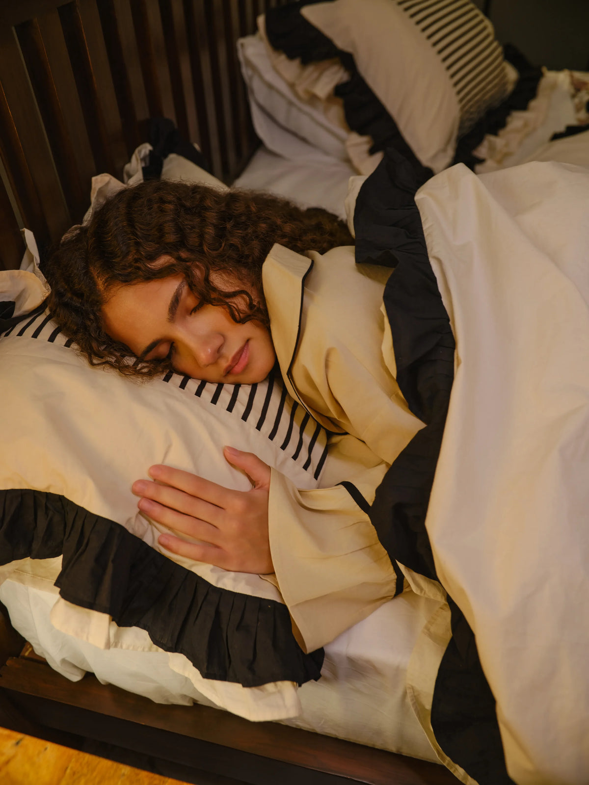 The Madeleine Set by Uahan, asleep under a ruffled duvet