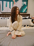 The Madeleine Set by Uahan, sitting on a striped bed