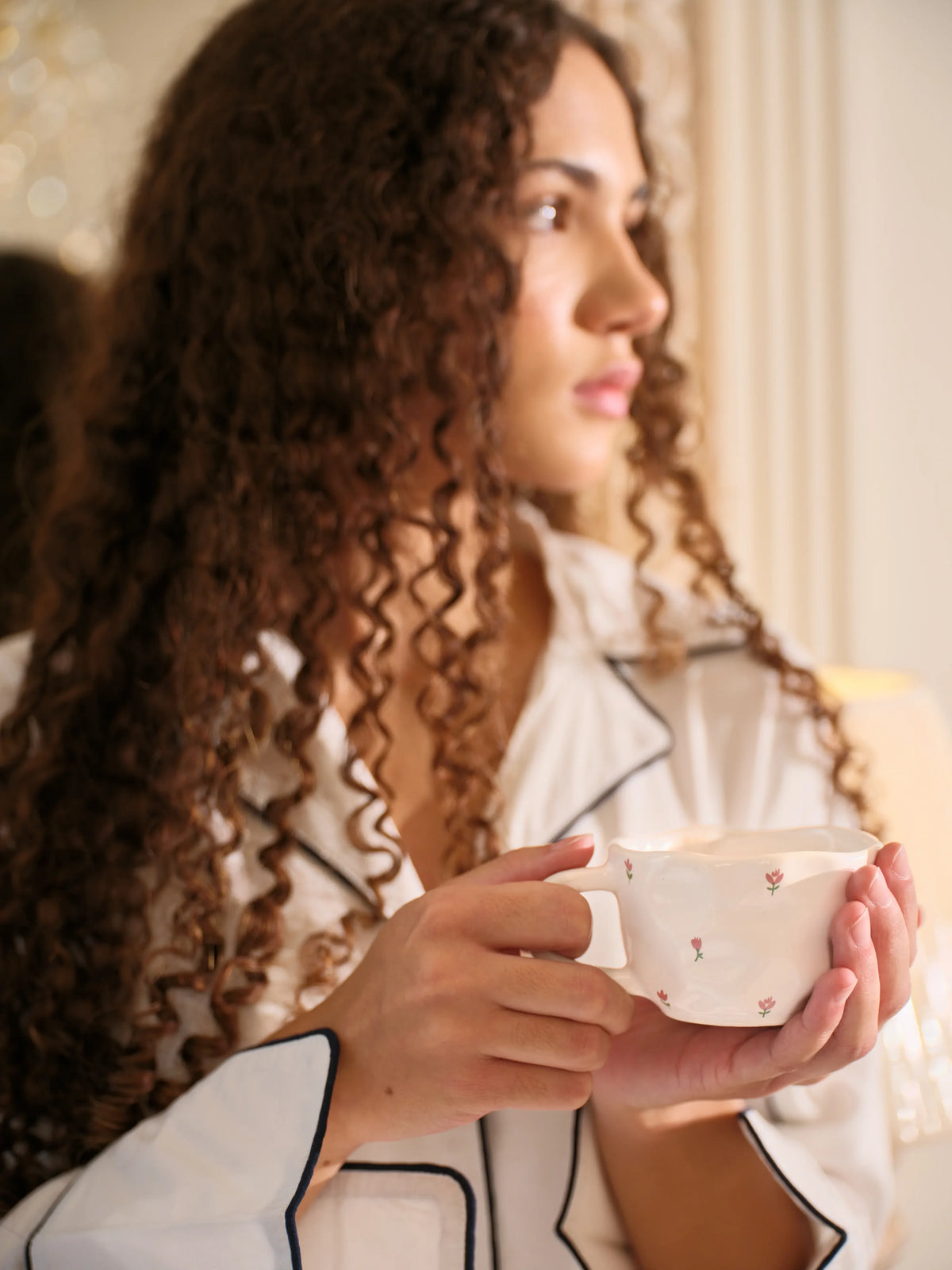 The Opaline Set by Uahan — navy-blue piped collar and cuffs, with a floral tea cup