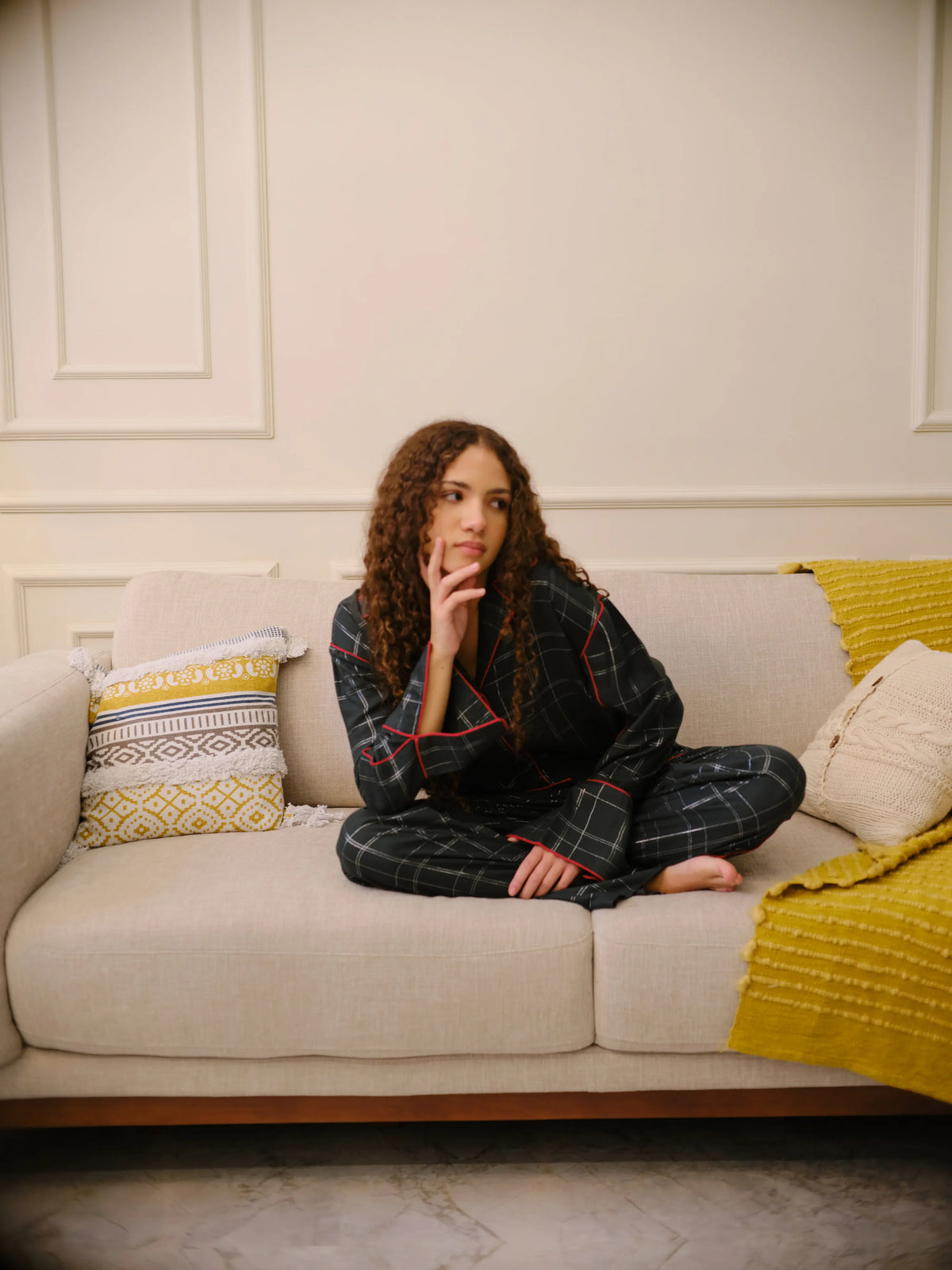 The Sorbonne Set by Uahan, curled up on a linen sofa